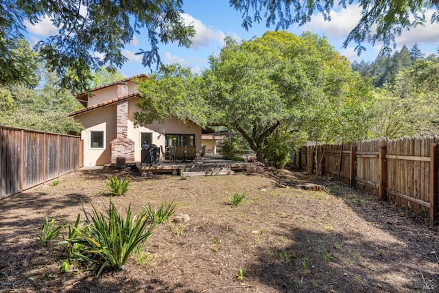 view of yard with a fenced backyard and a deck