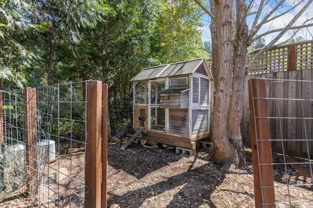 view of outdoor structure with an outbuilding and a fenced backyard