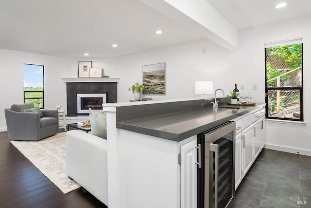 2532 Laguna Vista Dr, Novato, CA 94945 - kitchen featuring beverage cooler, a peninsula, a sink, white cabinetry, and dark countertops