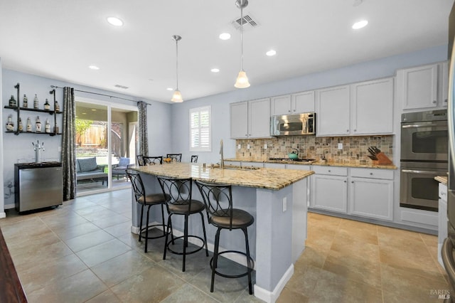 2436 Chuck Hammond Dr, Fairfield, CA 94533 - kitchen featuring tasteful backsplash, visible vents, a sink, stainless steel appliances, and light stone counters