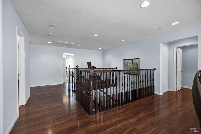 2436 Chuck Hammond Dr, Fairfield, CA 94533 - corridor featuring a textured ceiling, recessed lighting, wood finished floors, an upstairs landing, and baseboards