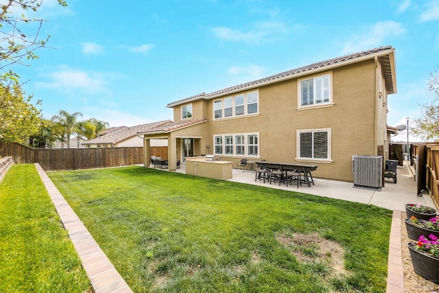 2436 Chuck Hammond Dr, Fairfield, CA 94533 - back of house featuring a yard, a fenced backyard, a tile roof, a patio, and stucco siding