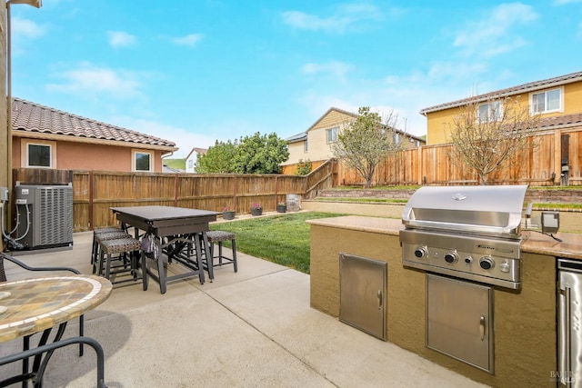 2436 Chuck Hammond Dr, Fairfield, CA 94533 - view of patio / terrace with a fenced backyard, grilling area, exterior kitchen, outdoor dining space, and central AC unit