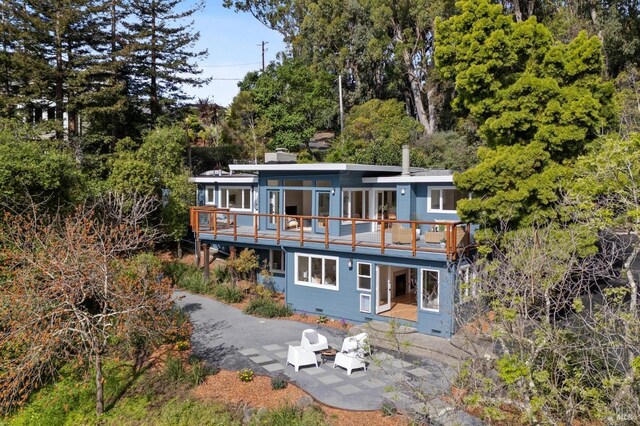 back of property with a deck