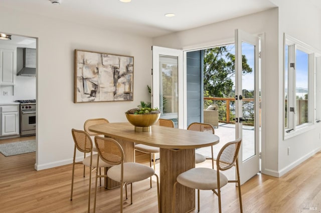 dining space with recessed lighting, light wood-style flooring, baseboards, and french doors