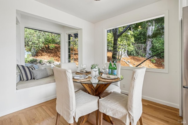dining room with baseboards and wood finished floors