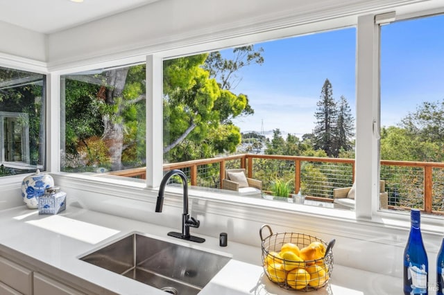 interior space featuring a wealth of natural light, light countertops, and a sink