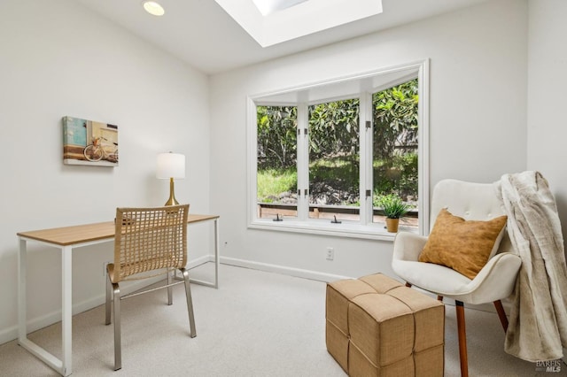 carpeted home office with baseboards and a skylight