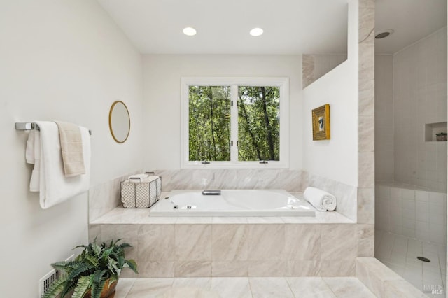 full bath featuring recessed lighting, a bath, and a walk in shower