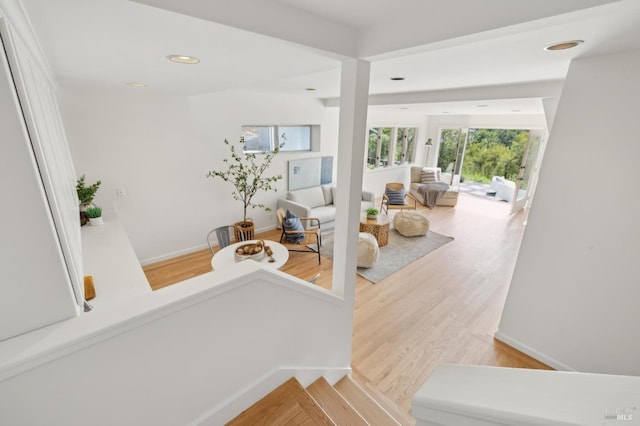 stairway featuring recessed lighting and wood finished floors