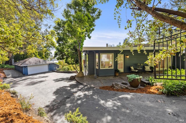 single story home with an outbuilding and a detached garage