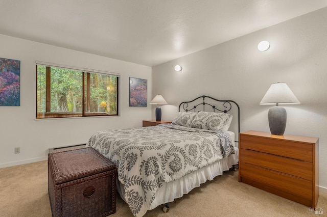 carpeted bedroom with a baseboard radiator and baseboards