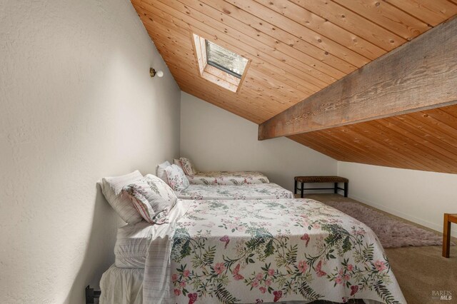 bedroom with carpet, wood ceiling, baseboards, and lofted ceiling with skylight