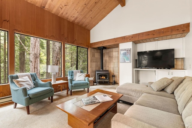 living area featuring a wealth of natural light, a wood stove, high vaulted ceiling, and beamed ceiling