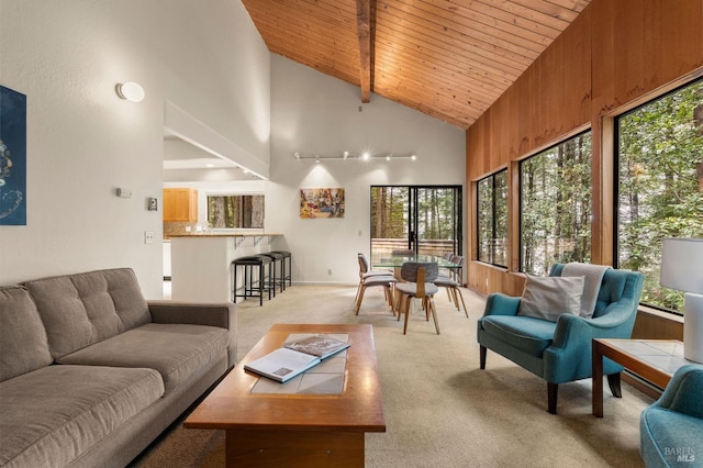 living room with light colored carpet, wooden ceiling, high vaulted ceiling, and beam ceiling