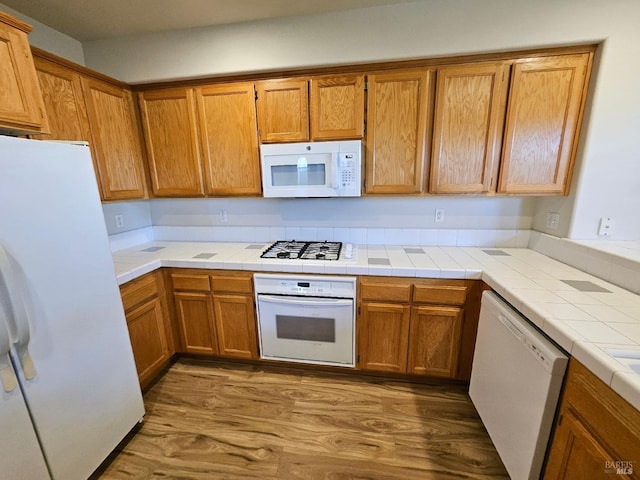 43 Johnson St, Windsor, CA 95492 - kitchen featuring brown cabinetry, white appliances, and wood finished floors