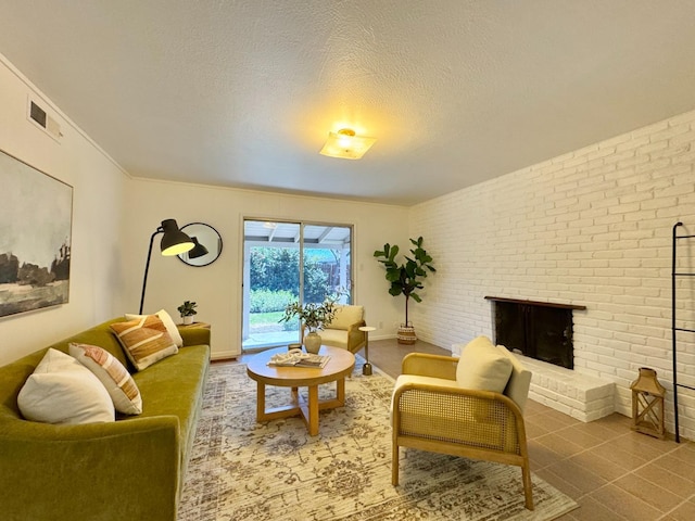 living room featuring baseboards, visible vents, a textured ceiling, and a brick fireplace