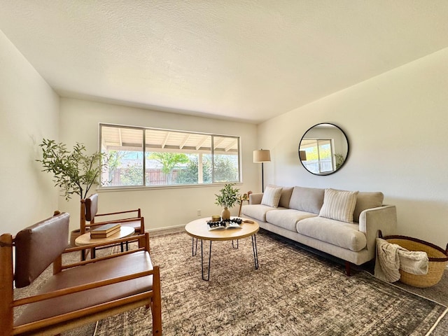 carpeted living area with baseboards