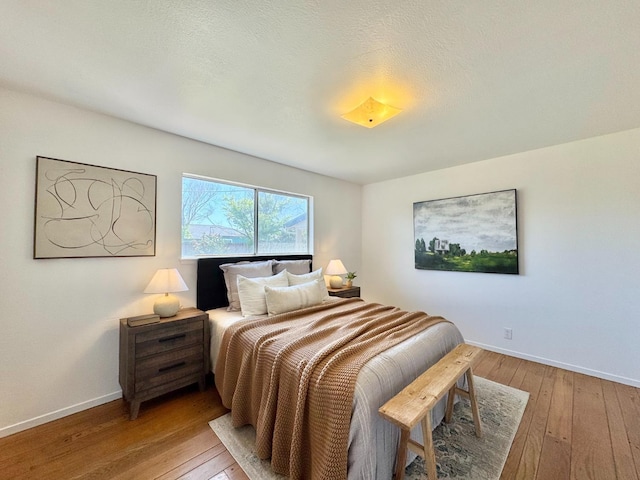 bedroom featuring baseboards and light wood-style floors