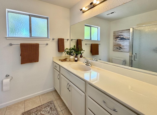 full bath featuring tile patterned floors, toilet, vanity, visible vents, and a stall shower