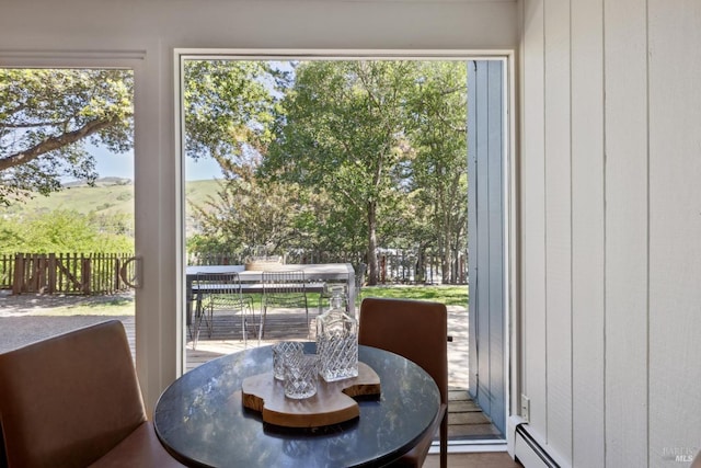 sunroom / solarium featuring baseboard heating