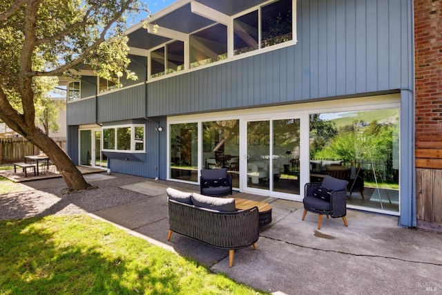 back of property featuring a patio and a balcony