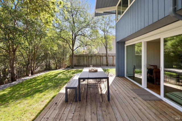 wooden deck featuring a yard, fence, and outdoor dining area