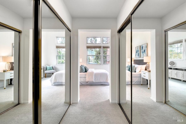 hall featuring light carpet