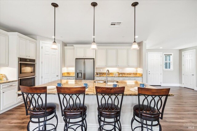 1012 Capitola Ct, Vacaville, CA 95687 - kitchen with appliances with stainless steel finishes, dark wood finished floors, white cabinets, and recessed lighting