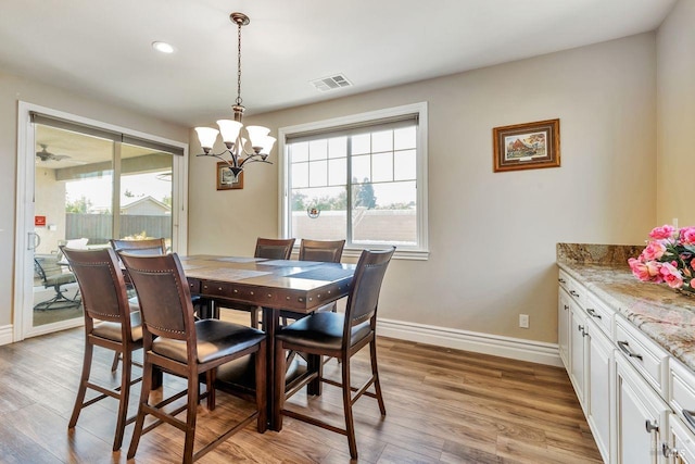 dining space featuring visible vents, baseboards, an inviting chandelier, recessed lighting, and light wood-style flooring