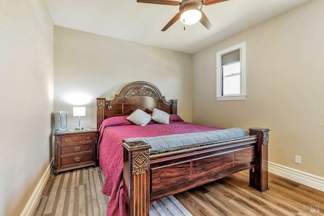bedroom with baseboards, a ceiling fan, and wood finished floors