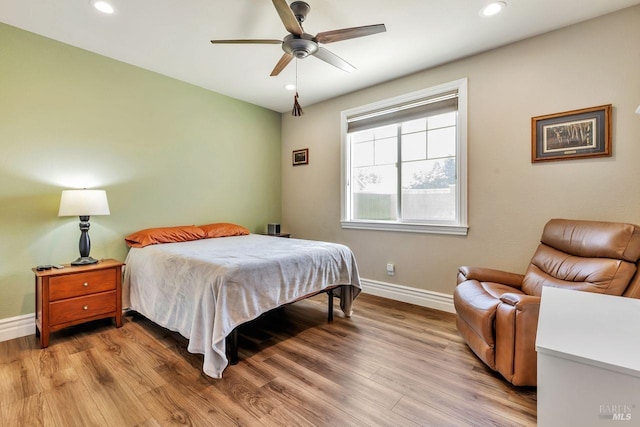 bedroom with light wood-type flooring, ceiling fan, baseboards, and recessed lighting