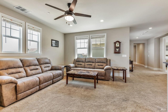 living area with ceiling fan, visible vents, recessed lighting, light carpet, and plenty of natural light