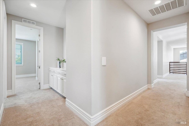 1012 Capitola Ct, Vacaville, CA 95687 - hall featuring light colored carpet, recessed lighting, and an upstairs landing