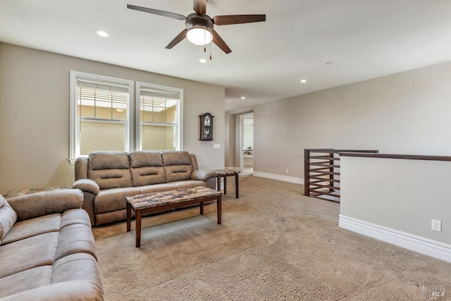 living room featuring ceiling fan, recessed lighting, light colored carpet, and baseboards