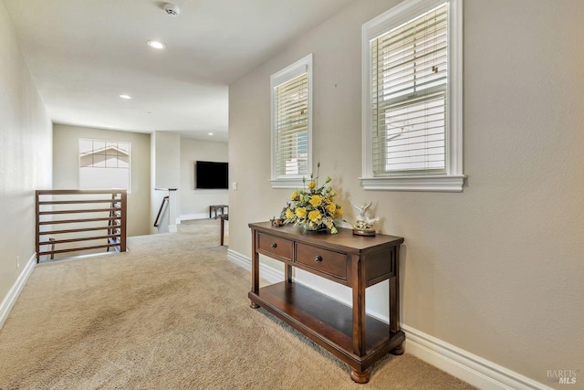 corridor with baseboards, carpet, an upstairs landing, and recessed lighting