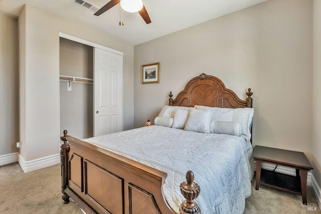 bedroom featuring visible vents, baseboards, a closet, a ceiling fan, and light carpet