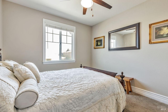 carpeted bedroom with baseboards and a ceiling fan