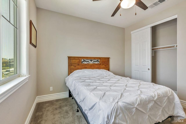 bedroom featuring visible vents, baseboards, a closet, a ceiling fan, and carpet flooring