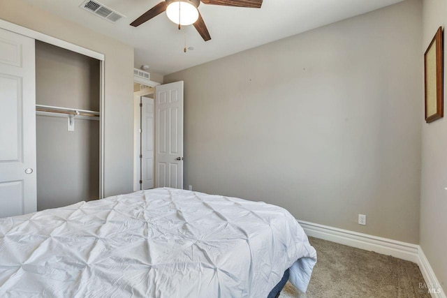 carpeted bedroom featuring visible vents, a closet, baseboards, and ceiling fan
