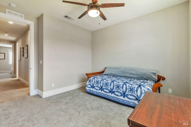 carpeted bedroom with visible vents, baseboards, and a ceiling fan