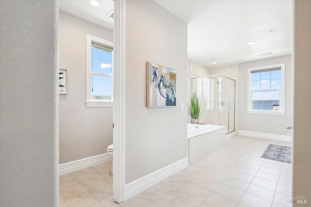 1012 Capitola Ct, Vacaville, CA 95687 - hallway featuring plenty of natural light and tile patterned flooring