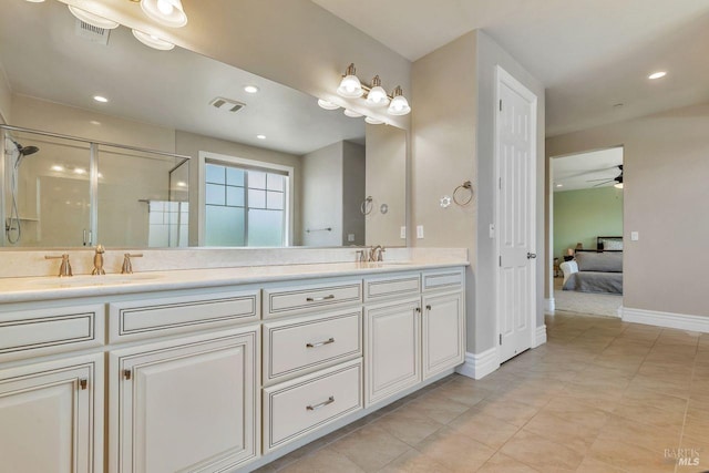 bathroom with a shower stall, double vanity, visible vents, and a sink