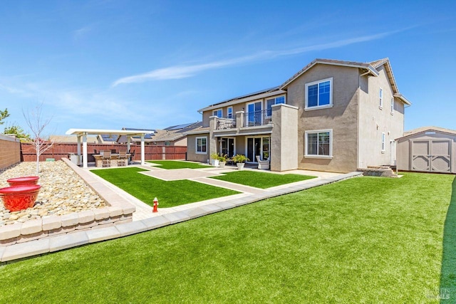 back of property with a fenced backyard, a patio, a storage unit, an outbuilding, and stucco siding