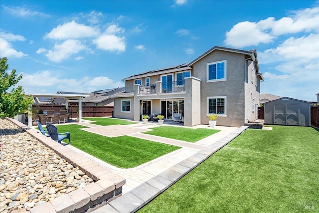 1012 Capitola Ct, Vacaville, CA 95687 - rear view of property with a balcony, a patio, a storage unit, stucco siding, and roof mounted solar panels
