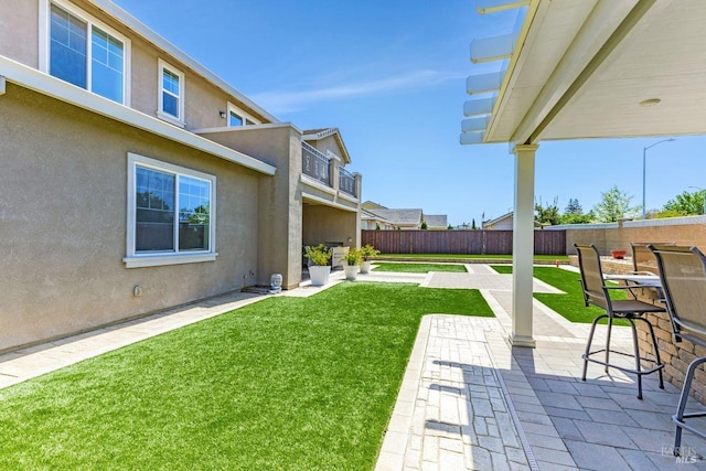 view of yard with a patio and fence