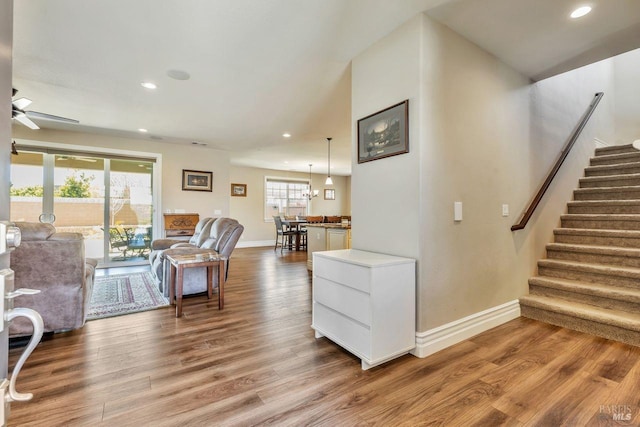 living area with baseboards, recessed lighting, stairs, ceiling fan, and wood finished floors