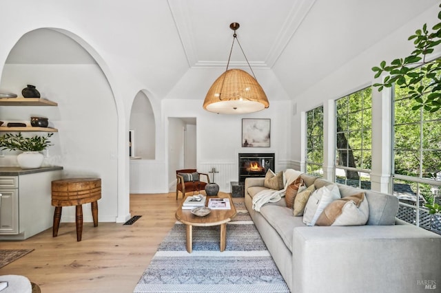 354 Forrest Ave, Fairfax, CA 94930 - living room featuring plenty of natural light, light wood-style floors, a glass covered fireplace, lofted ceiling, and a wainscoted wall