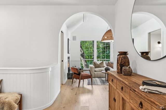 354 Forrest Ave, Fairfax, CA 94930 - living area with light wood-type flooring, a wainscoted wall, and arched walkways