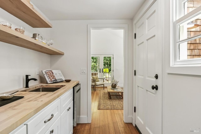 354 Forrest Ave, Fairfax, CA 94930 - kitchen featuring open shelves, light wood-type flooring, white cabinets, dishwasher, and butcher block counters